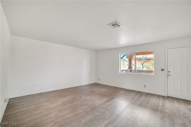 spare room with wood-type flooring