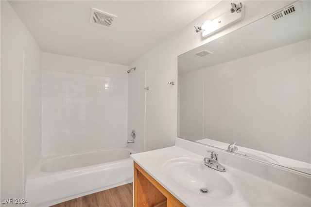 bathroom featuring tub / shower combination, vanity, and hardwood / wood-style flooring