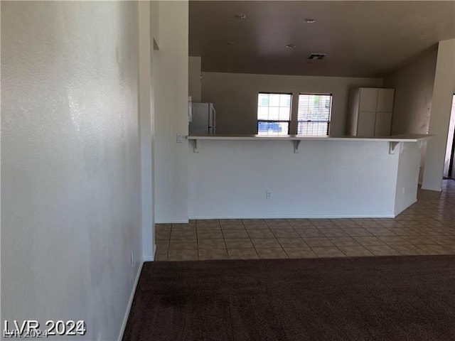 unfurnished room with light tile patterned floors