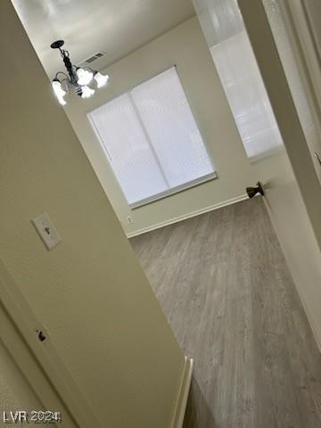 room details with hardwood / wood-style floors and a chandelier