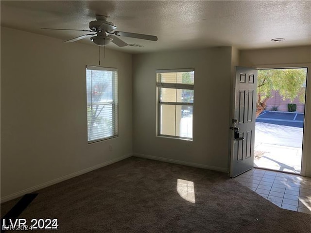 entryway featuring ceiling fan and carpet flooring