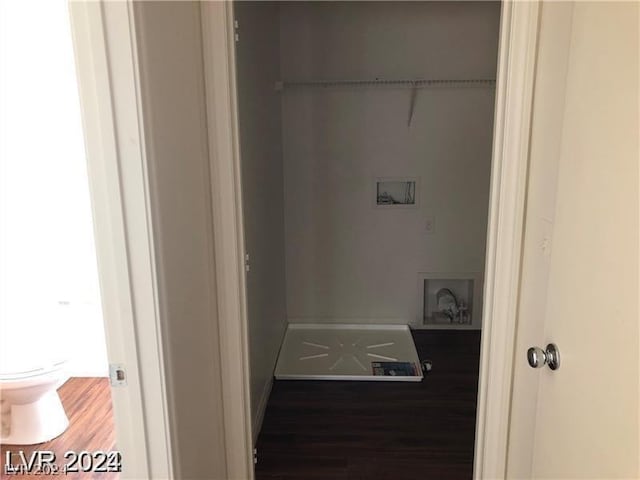 interior space with washer hookup and dark wood-type flooring