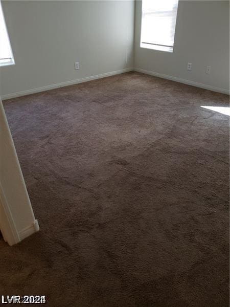 empty room with dark carpet