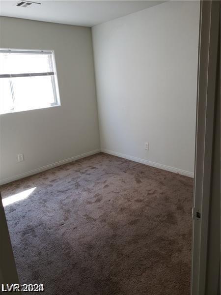 unfurnished room featuring carpet