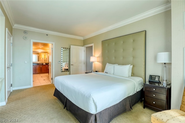 bedroom with ornamental molding and ensuite bathroom