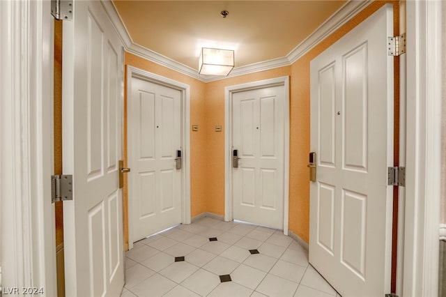 tiled foyer featuring crown molding