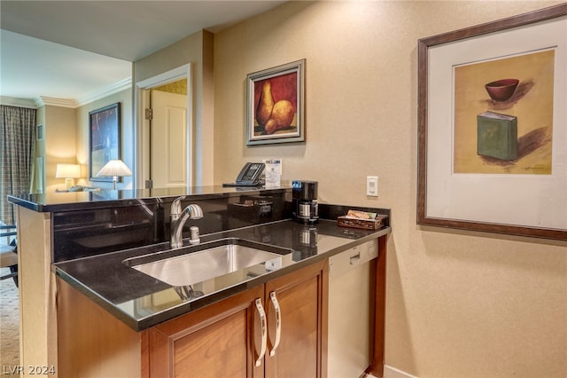 kitchen with stainless steel dishwasher, ornamental molding, sink, and dark stone counters