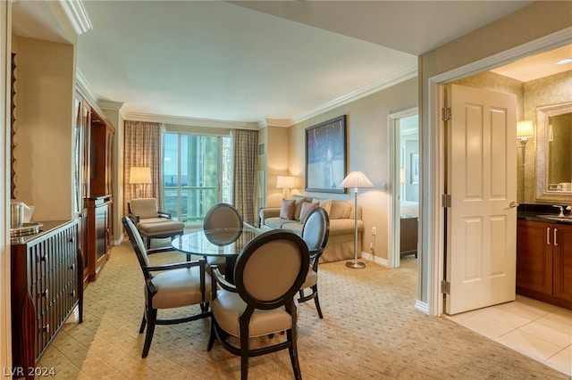 dining space with crown molding and sink