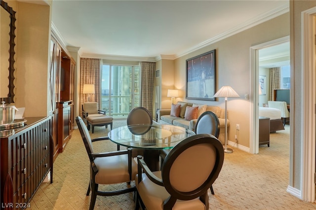 carpeted dining area featuring ornamental molding