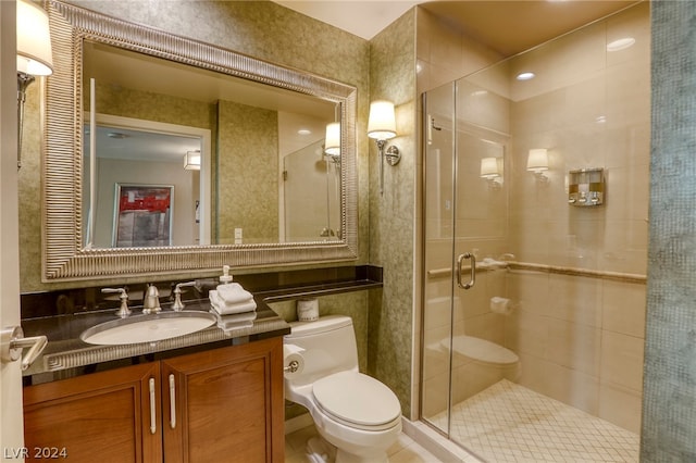 bathroom with vanity, toilet, and an enclosed shower