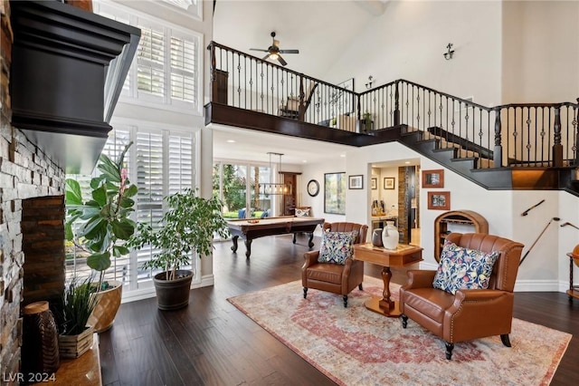 living room featuring pool table, ceiling fan, dark hardwood / wood-style flooring, and a high ceiling