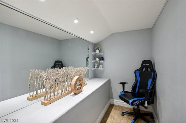 home office featuring carpet and vaulted ceiling