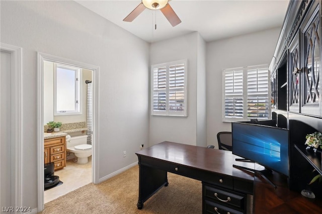 carpeted home office with ceiling fan