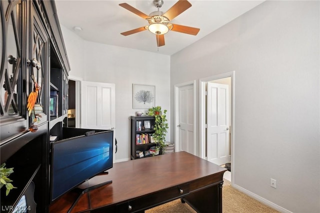 carpeted office featuring ceiling fan