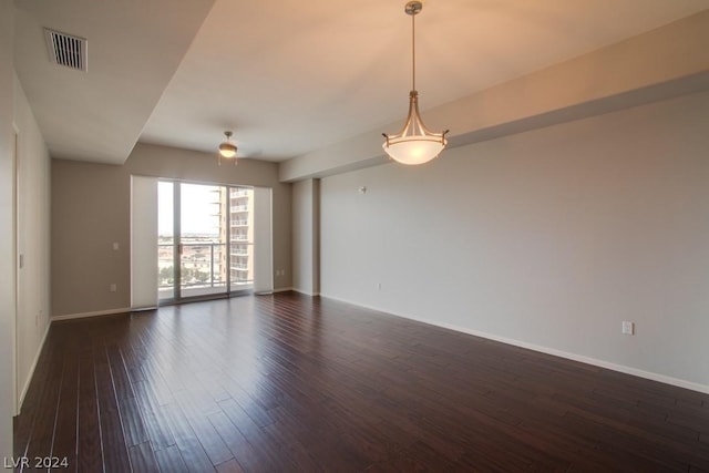 spare room featuring dark wood-type flooring