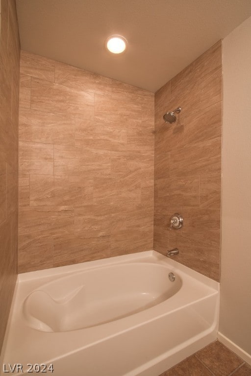 bathroom with tile patterned flooring and shower / tub combination