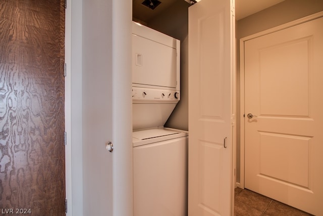 washroom with tile patterned floors and stacked washer and clothes dryer