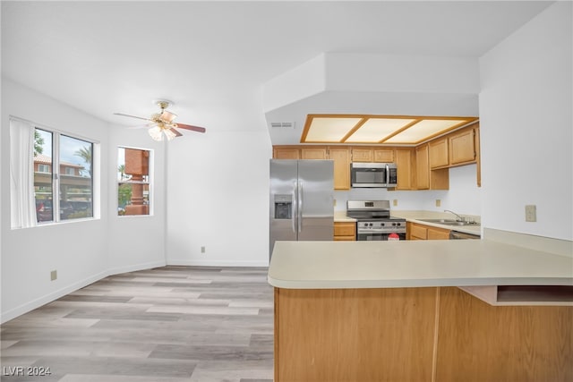 kitchen featuring ceiling fan, light wood-type flooring, sink, appliances with stainless steel finishes, and kitchen peninsula