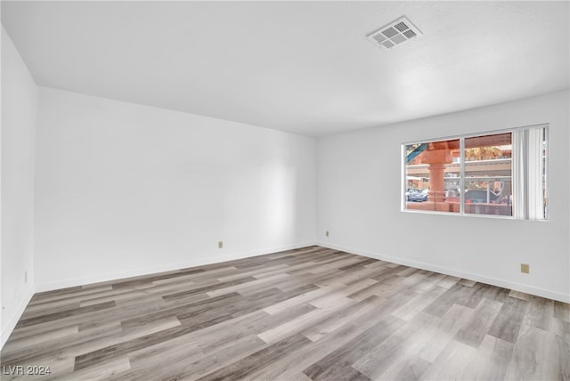 unfurnished room featuring hardwood / wood-style flooring