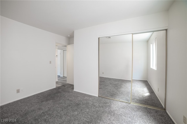 unfurnished bedroom featuring a closet and carpet