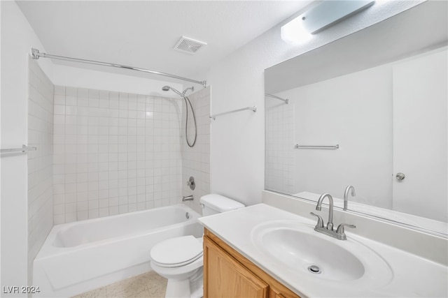 full bathroom with toilet, tile patterned floors, tiled shower / bath combo, and vanity