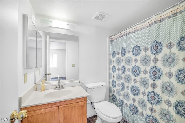 bathroom with vanity, hardwood / wood-style flooring, and toilet