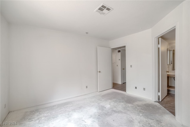 unfurnished bedroom with wood-type flooring and ensuite bathroom