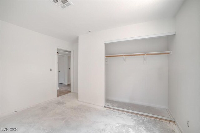 845 Mesquite Springs Dr Unit 101, Mesquite, NV 89027 - unfurnished bedroom with unfinished concrete floors, a closet, and visible vents
