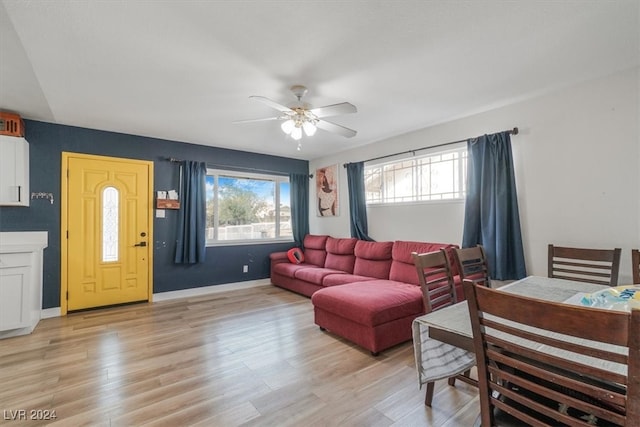 living room featuring light hardwood / wood-style flooring and ceiling fan