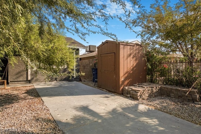 exterior space with a shed and a patio area