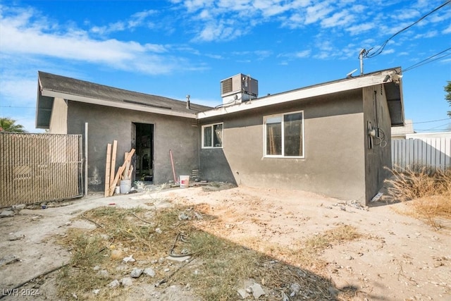 back of property featuring central air condition unit