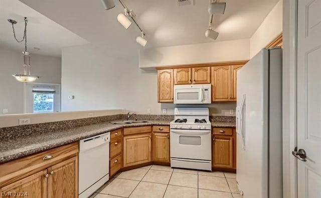 kitchen with white appliances, light tile patterned floors, track lighting, hanging light fixtures, and sink