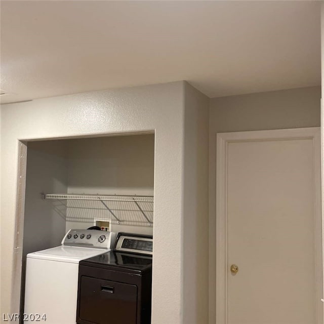 washroom featuring washer and clothes dryer