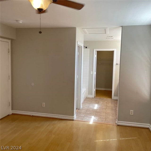 empty room with light hardwood / wood-style floors and ceiling fan