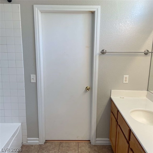 bathroom featuring tile patterned flooring and vanity