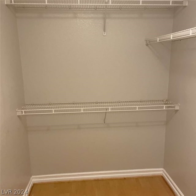 walk in closet featuring hardwood / wood-style flooring