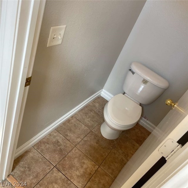 bathroom featuring toilet and tile patterned floors