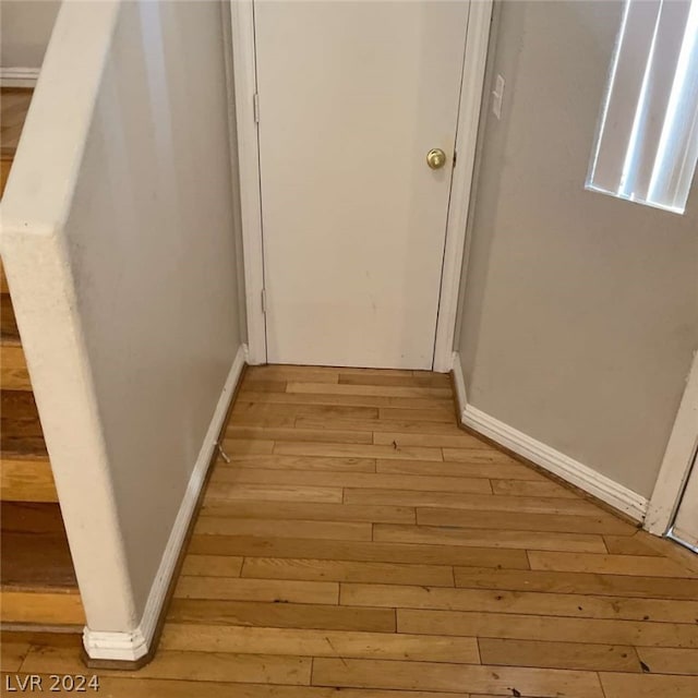 hallway with light hardwood / wood-style flooring