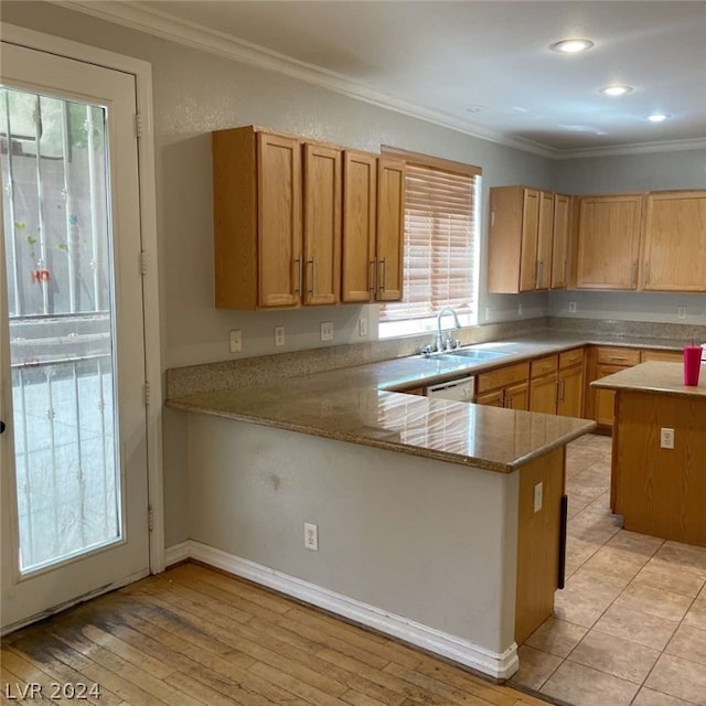 kitchen with a healthy amount of sunlight, light hardwood / wood-style flooring, and kitchen peninsula