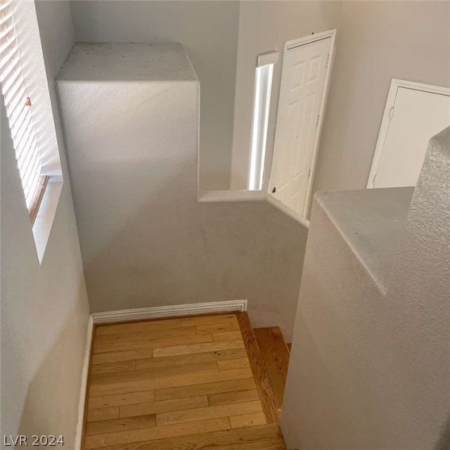 stairs featuring light hardwood / wood-style floors