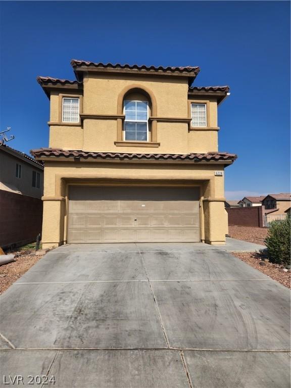 mediterranean / spanish-style home with a garage