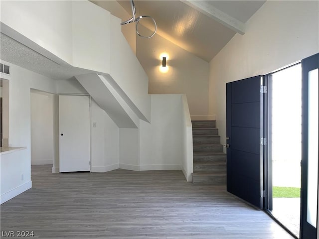 bonus room featuring hardwood / wood-style flooring, high vaulted ceiling, and beamed ceiling