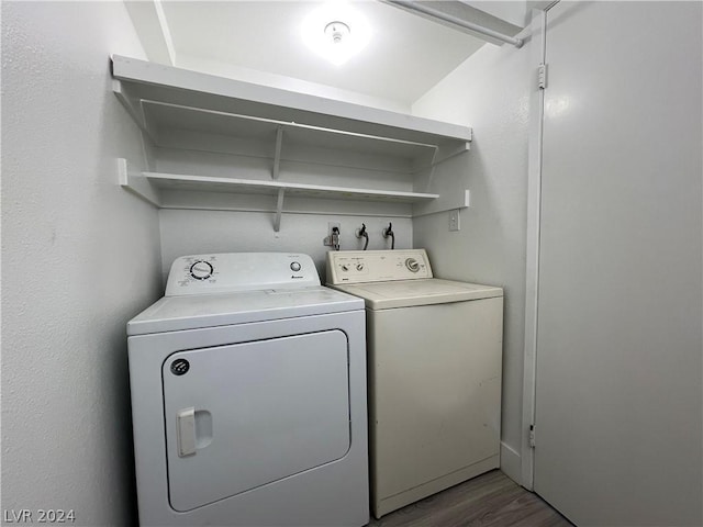 washroom featuring washing machine and dryer and hardwood / wood-style floors