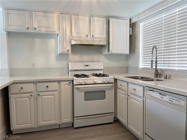 kitchen featuring white cabinetry, dark hardwood / wood-style flooring, sink, and white appliances