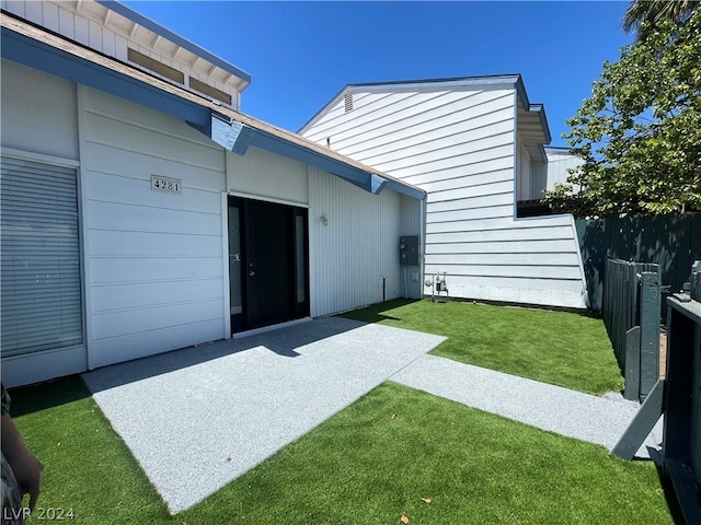 back of house featuring a yard and a patio