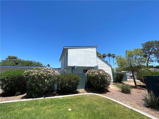 view of property exterior featuring a lawn