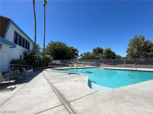4281 White Sands Ave, Las Vegas, NV 89121 - community pool featuring a patio and fence