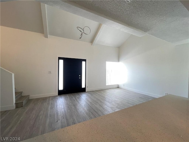 entrance foyer featuring beam ceiling, high vaulted ceiling, dark hardwood / wood-style floors, and a textured ceiling