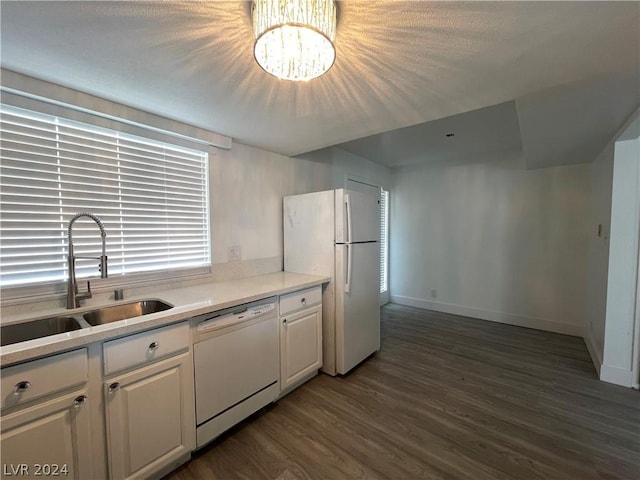 4281 White Sands Ave, Las Vegas, NV 89121 - kitchen featuring white appliances, a sink, dark wood-type flooring, white cabinetry, and light countertops