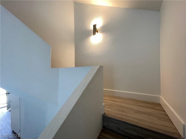 stairway with hardwood / wood-style flooring